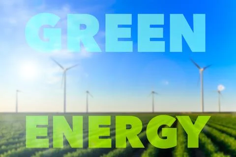 Blurred image of windmills at sunset at a field of crops. Text green energy s Stock Illustration