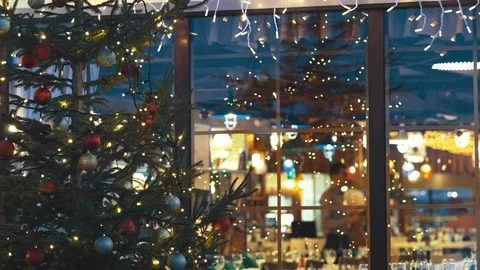 Blurred image in the window interior of a beautiful restaurant. Christmas tree Stock Footage 94449864