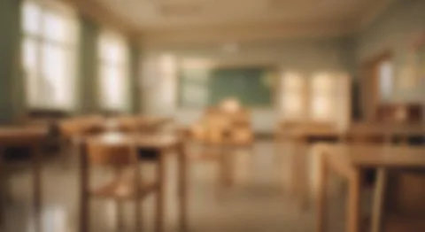 Blurred interior photo of an empty school classroom with desks, chairs and .. Foto stock