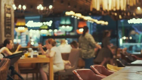 Blurred the interior restaurant bright lighting. Family sitting at a restaurant Stock Footage 92866465