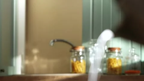 Blurred kitchen background with water stream flowing out of focus near pasta Stock Footage 332501102