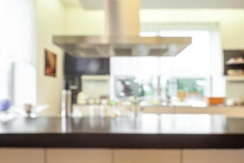 Blurred kitchen interior with modern functional appliances and furniture Stock Photos