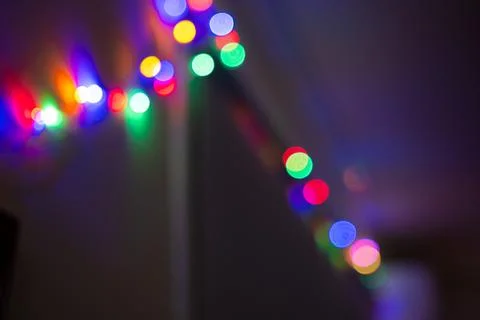 Blurred LED Christmas string lights with colorful bokeh, creating a festive Stock Photos