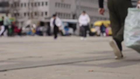 Blurred Legs Walking in Slow Motion Past Food Trucks on City Street (4K) Stock Footage 309461017