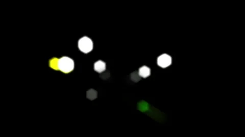 Blurred light captured by a camera lens panning toward the viewer 動画素材 340253204