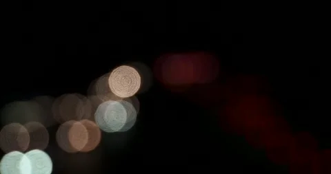 Blurred lights of headlights moving night traffic out of focus backlight Stock Footage 242779055