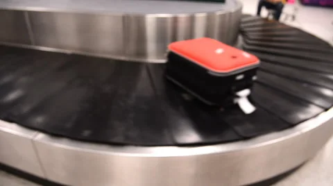 Blurred luggage passing by while on baggage carousel Stock Footage
