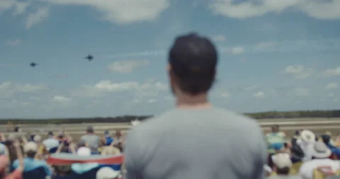 Blurred man and crowd of people watching aerobatic squadron flying in sky Video stock 147112352