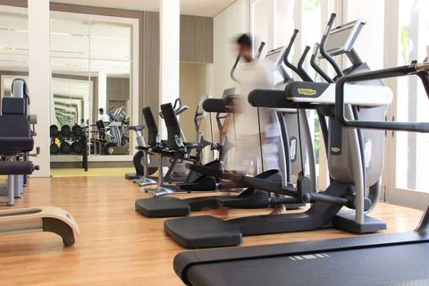 Blurred man in a gym with Technogym with exercise equipment Stock Photos