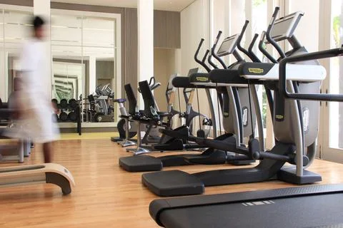 Blurred man in a gym with Technogym with exercise equipment Stock Photos
