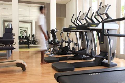 Blurred man in a gym with Technogym with exercise equipment Stock Photos