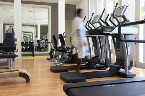 Blurred man in a gym with Technogym with exercise equipment Stock Photos