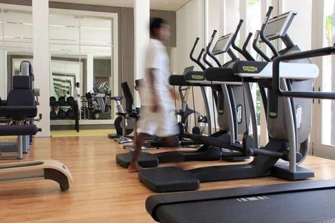 Blurred man in a gym with Technogym with exercise equipment Stock Photos