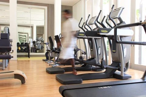 Blurred man in a gym with Technogym with exercise equipment Stock Photos