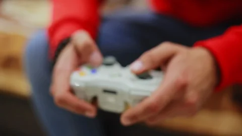 Blurred man playing video game at home. Close-up using the game controller. Stock Footage 95930347