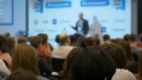 Blurred man showing screen and speech at business education conference at forum Stock Footage 88592200