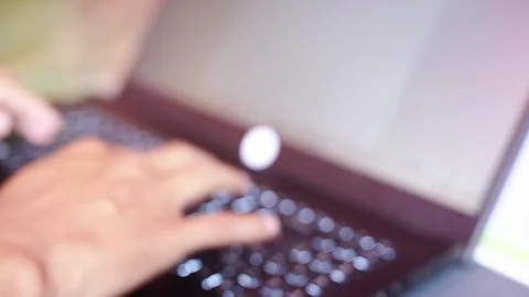 Blurred A man is typing on a laptop computer. Stock Footage 322116081