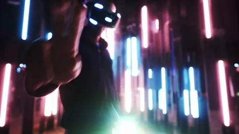 Blurred man wearing VR headset in neon lights Video stock 103630614