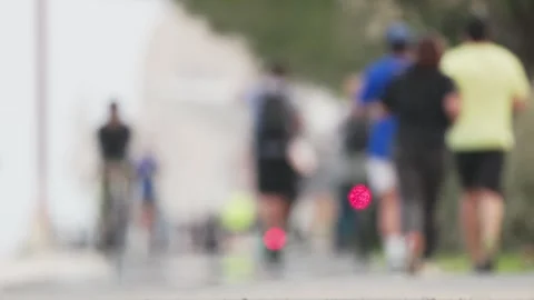 Blurred marathon runners with red light on asphalt road Stock Footage 307176194