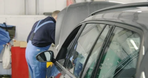 Blurred Mechanic Working On Car Engine Bay In The Dealer Service Video stock 124956496