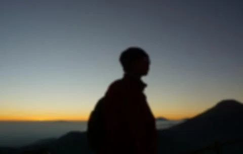 Blurred of Men are Standing Behind of Sunrise in Sikunir Hill Dieng Stock Photos
