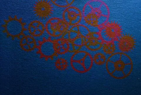 Blurred metal gears pattern on textured blue background 库存照片