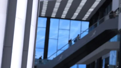 Blurred modern architecture with people moving across glass bridges Stock Footage 339486682