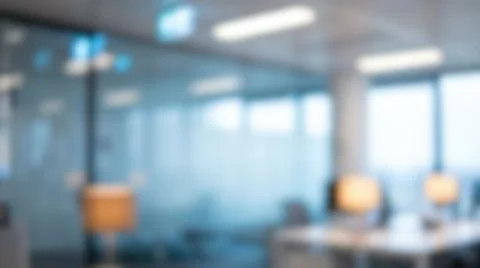 Blurred modern office workspace interior featuring empty desks illuminated .. Foto stock