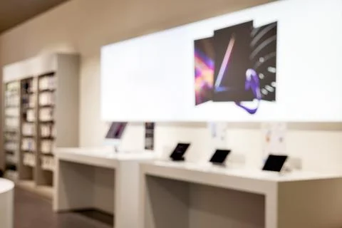 Blurred modern technology store interior with abstract display Stock Photos