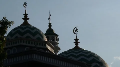 Blurred mosque domes with crescent moon symbols at sunset, spiritual atmosp.. Stock Footage 345198738