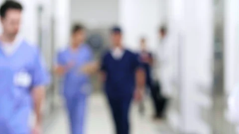 Blurred motion of doctors walking through corridor in hospital Video stock 105219709