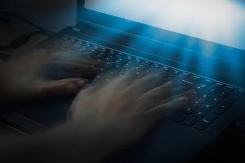 Blurred motion of hand typing on keyboad Foto stock