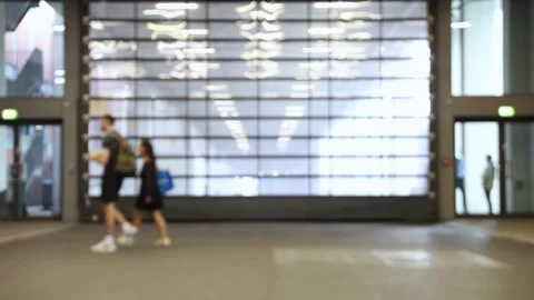 Blurred motion of a handful of people walking through shot at a trade fair. Stock Footage 344309102