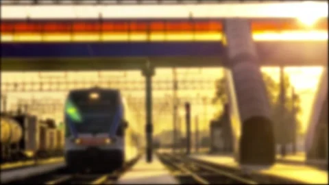 Blurred motion of passenger train arriving at railway station platform, bathed 库存影片 344095816