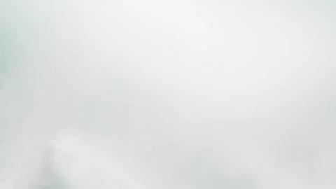Blurred motion of white fluffy feathers falling and flying over blue chroma key Stock Footage 170532701