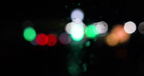 Blurred multi-colored lanterns and headlights of cars through the windshield Vídeos de archivo 268433466