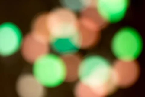 Blurred multicolored lights on a dark background. Stock Photos