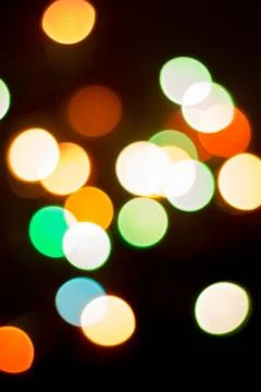 Blurred multicolored lights on a dark background. Stock Photos