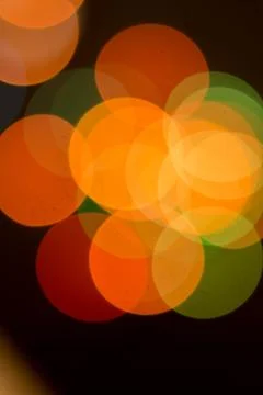 Blurred multicolored lights on a dark background. Stock Photos