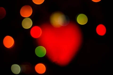 Blurred multicolored lights on a dark background. Stock Photos