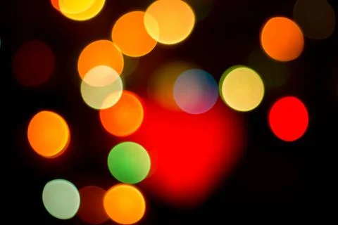 Blurred multicolored lights on a dark background. Stock Photos