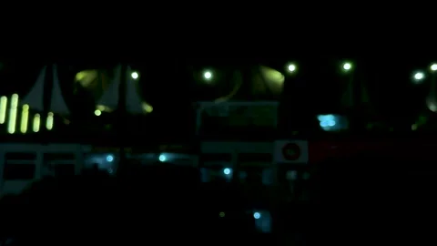 Blurred night cityscape with glowing lights and dark silhouettes against a .. Stock Footage 340220820