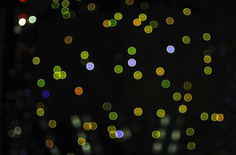 Blurred night multi colored glowing lights on black background. new year and  Stock-Fotos