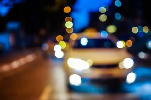 Blurred night street with car and lights bokeh Stock Photos
