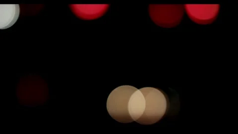 Blurred night traffic lights create colorful bokeh circles moving Video stock 329816377