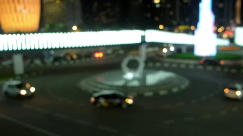Blurred night traffic rotating around roundabout with bright lights. Video stock 311474874