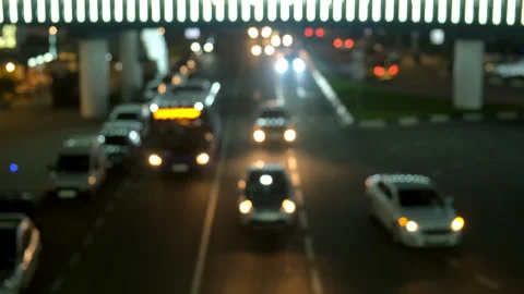 Blurred night traffic under a bridge with light trails in city infrastructure. Stock Footage 311475056