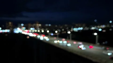 Blurred night view of city with bridge view and cars passing on illuminated road Stock Footage 305826093