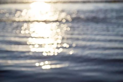 Blurred ocean background with reflections and bokeh Stock Photos