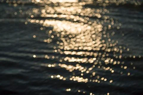 Blurred ocean background with reflections and bokeh Stock Photos